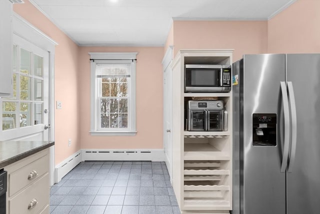 kitchen with white cabinetry, light tile patterned floors, and stainless steel appliances