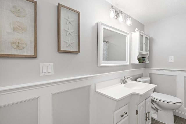 100 Elm St, Marshfield, MA 02050 - bathroom featuring vanity, wainscoting, and a decorative wall