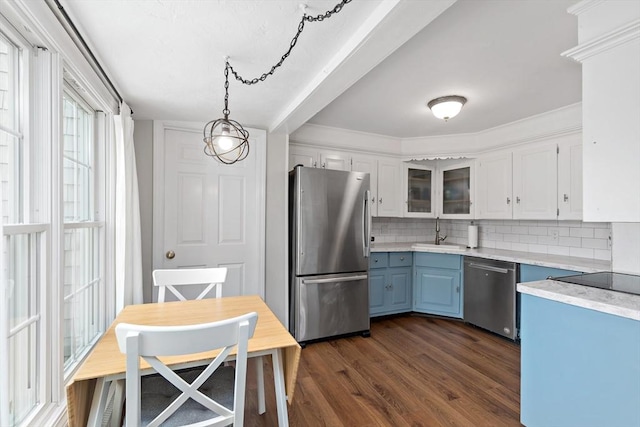 100 Elm St, Marshfield, MA 02050 - kitchen featuring appliances with stainless steel finishes, decorative backsplash, blue cabinets, light countertops, and white cabinetry