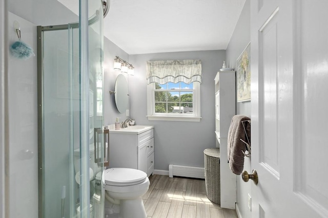 100 Elm St, Marshfield, MA 02050 - bathroom featuring baseboard heating, vanity, a shower stall, and wood finished floors
