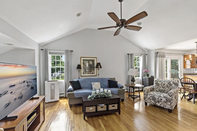 100 Elm St, Marshfield, MA 02050 - living area with lofted ceiling, ceiling fan, light wood finished floors, and a chandelier