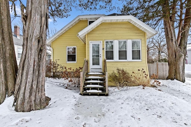 bungalow-style home featuring fence