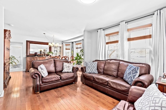 living room with a chandelier and light wood-style flooring