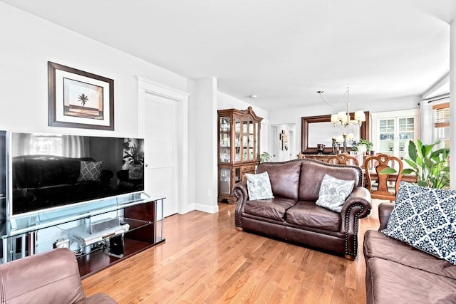 living room featuring light wood-style floors and a notable chandelier