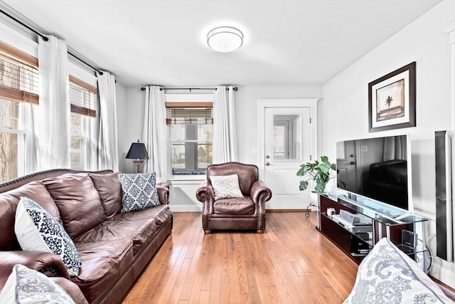 living room featuring light wood-type flooring and baseboards