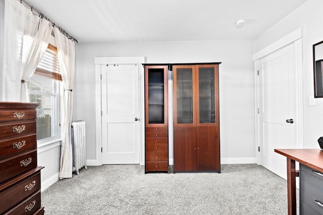 bedroom with radiator, carpet flooring, and baseboards