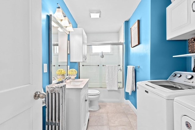 full bath featuring enclosed tub / shower combo, toilet, independent washer and dryer, tile patterned floors, and radiator heating unit