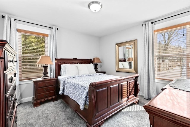 bedroom with baseboards and light colored carpet