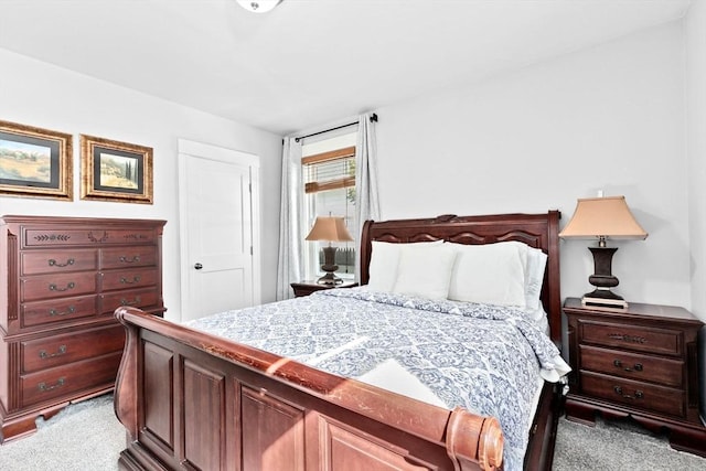 bedroom featuring light carpet