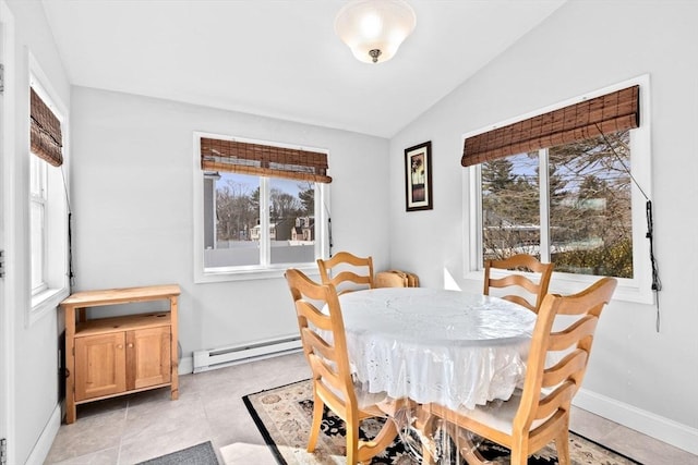 dining space featuring lofted ceiling, a baseboard radiator, and baseboards