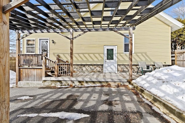 exterior space featuring fence, a deck, and a pergola