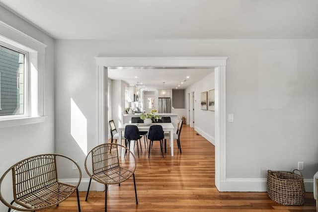 dining room with light wood-style flooring and baseboards