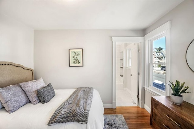 bedroom featuring baseboards and wood finished floors