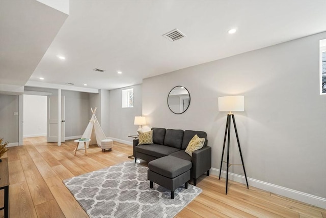 sitting room with hardwood / wood-style floors, recessed lighting, visible vents, and baseboards