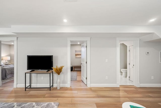 living room featuring recessed lighting, baseboards, and wood finished floors