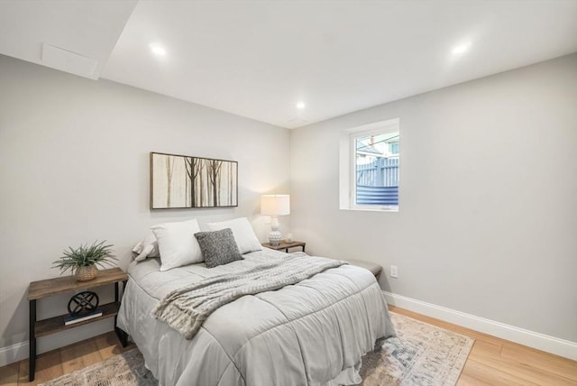 bedroom with recessed lighting, baseboards, and wood finished floors