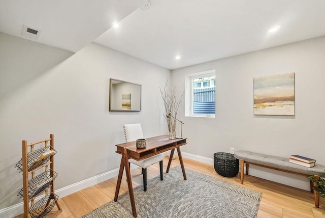 office space with baseboards, recessed lighting, visible vents, and light wood-style floors