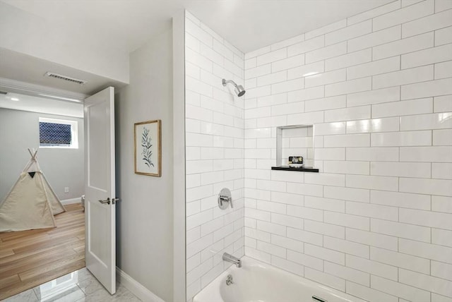 full bath with  shower combination, visible vents, and baseboards