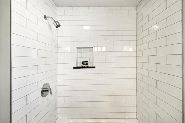 bathroom featuring walk in shower and a bathing tub