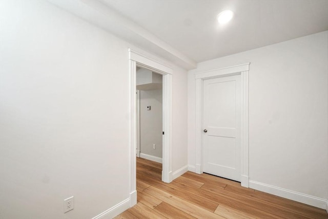 empty room featuring light wood-style floors and baseboards