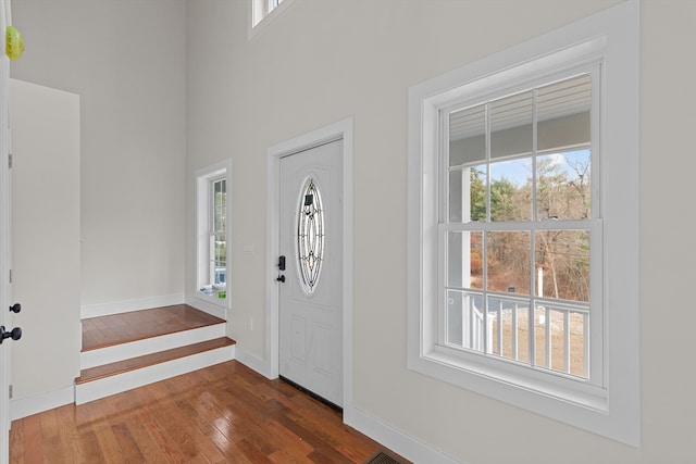 entryway with dark hardwood / wood-style flooring