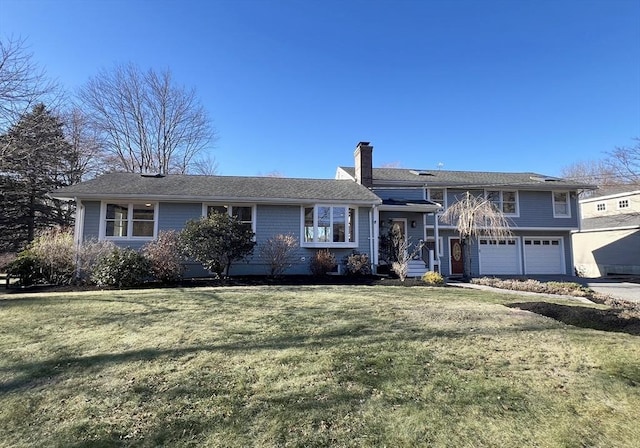 view of front of house featuring a front yard and a garage