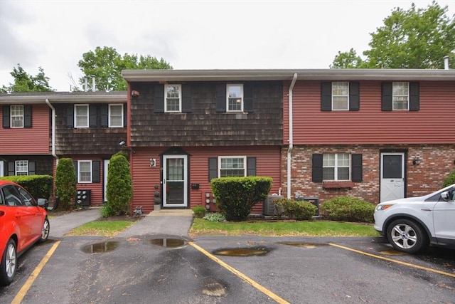 280 Elm St Unit 24, Marlborough, MA 01752 - view of property featuring uncovered parking, central AC, and brick siding