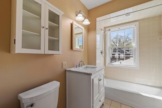 full bath featuring vanity, tile patterned floors, toilet, and  shower combination