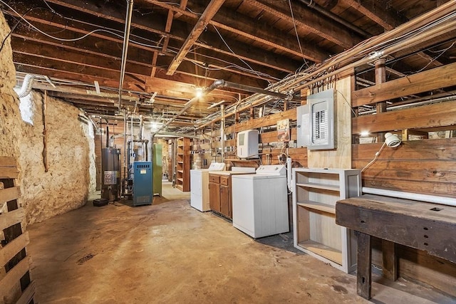 unfinished basement featuring washer and clothes dryer, heating unit, water heater, and a heating unit