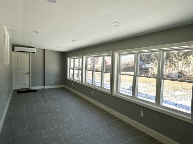 tiled empty room with a wall mounted air conditioner