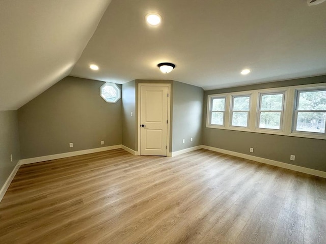 bonus room featuring light hardwood / wood-style floors and vaulted ceiling