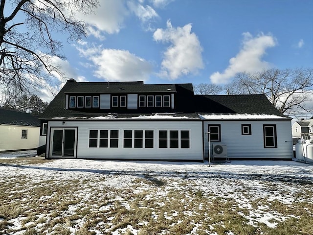 snow covered property featuring ac unit