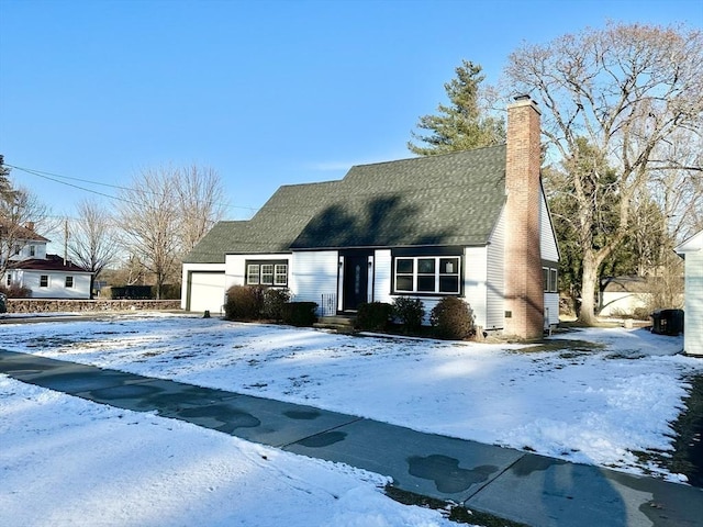 cape cod home with a garage