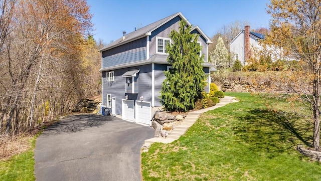 42 Sheffield Dr, Belchertown, MA 01007 - view of side of home featuring a lawn, an attached garage, and driveway