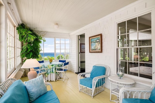 15 Brier Rd, Gloucester, MA 01930 - sunroom with plenty of natural light, a water view, wood finished floors, outdoor dining space, and crown molding