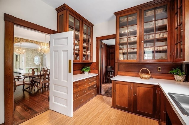 15 Brier Rd, Gloucester, MA 01930 - bar with a chandelier, light wood-type flooring, and decorative light fixtures
