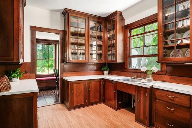 15 Brier Rd, Gloucester, MA 01930 - kitchen featuring light wood-style floors, light countertops, and glass insert cabinets