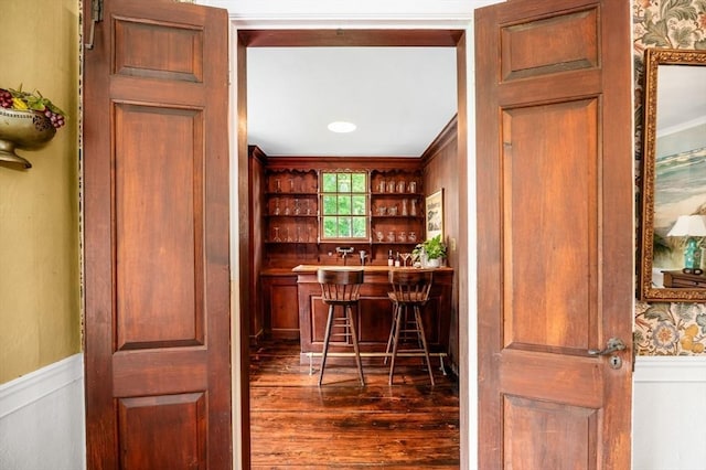 15 Brier Rd, Gloucester, MA 01930 - indoor dry bar featuring dark wood-type flooring, ornamental molding, wallpapered walls, and wainscoting