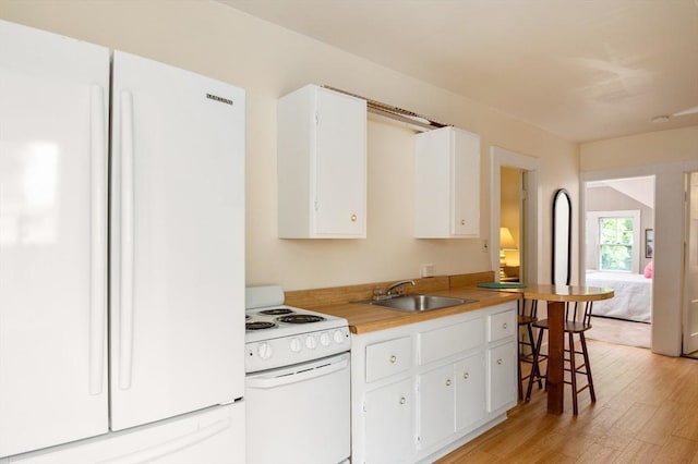 15 Brier Rd, Gloucester, MA 01930 - kitchen featuring white appliances, light wood finished floors, white cabinetry, and light countertops