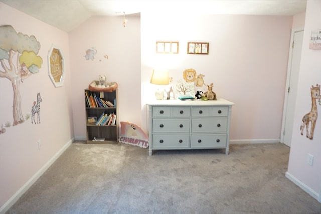 bedroom featuring lofted ceiling and light carpet