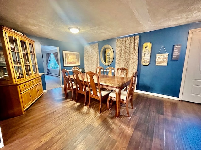 dining area featuring hardwood / wood-style floors and a textured ceiling