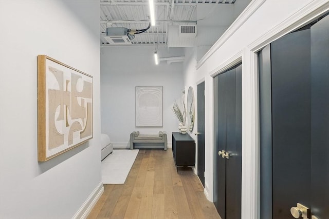 147 Sherman St Unit 201, Cambridge, MA 02140 - hallway with hardwood / wood-style floors, a towering ceiling, and baseboards
