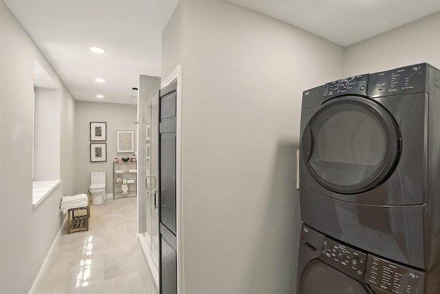 147 Sherman St Unit 201, Cambridge, MA 02140 - laundry room with stacked washer / dryer, baseboards, and recessed lighting