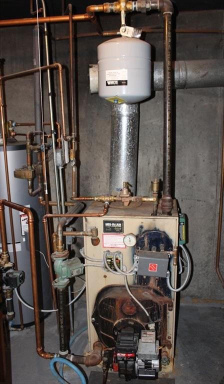 utility room featuring water heater