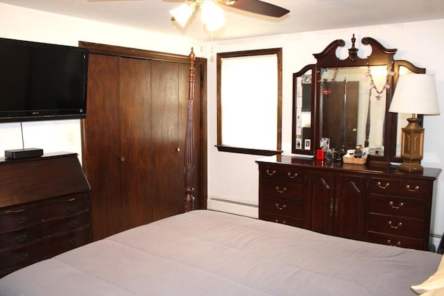 bedroom featuring a closet, a baseboard radiator, and a ceiling fan