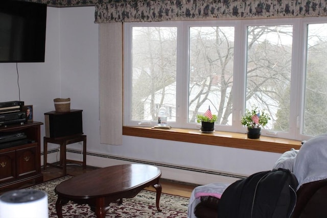 living area with a baseboard heating unit