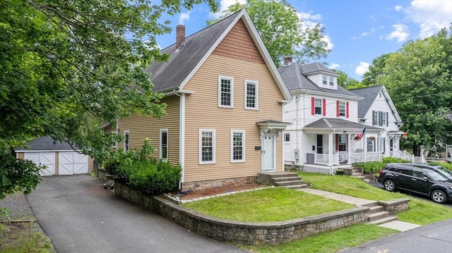 32 Dale St, Franklin, MA 02038 - view of front of house with a chimney, covered porch, an outdoor structure, a garage, and a front yard