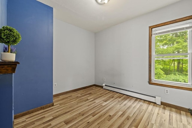 32 Dale St, Franklin, MA 02038 - spare room with a baseboard heating unit and light wood-style floors