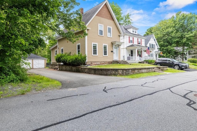 32 Dale St, Franklin, MA 02038 - view of front of house featuring an outdoor structure, a chimney, a garage, and a porch