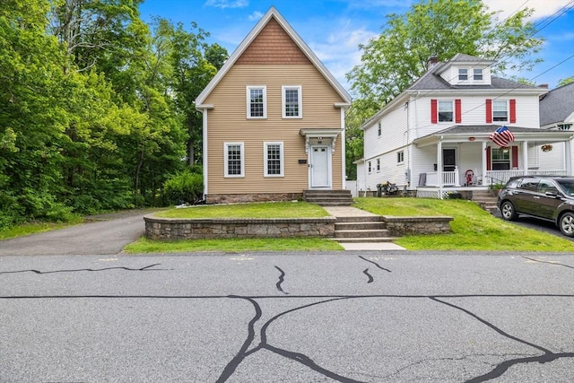 32 Dale St, Franklin, MA 02038 - view of front of home featuring a porch and a front yard